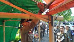 Anggota Satpol PP saat membongkar