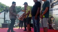 Bupati Kediri menyerahkan predikat juara di kontes ternak untuk katagori sapi kereman ektrem .