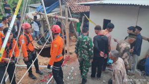 Petugas saat evakuasi jenazah dari dalam sumur.